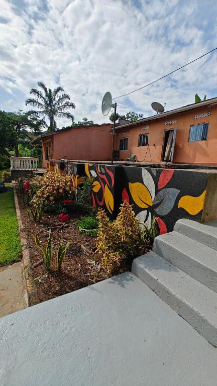 a wall with a painting on it in front of a house at Eco Cribs in Masaka