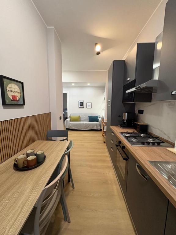 a kitchen with a wooden table and a dining room at Masonber trastevere centro Wi-Fi free balcone metro in Rome
