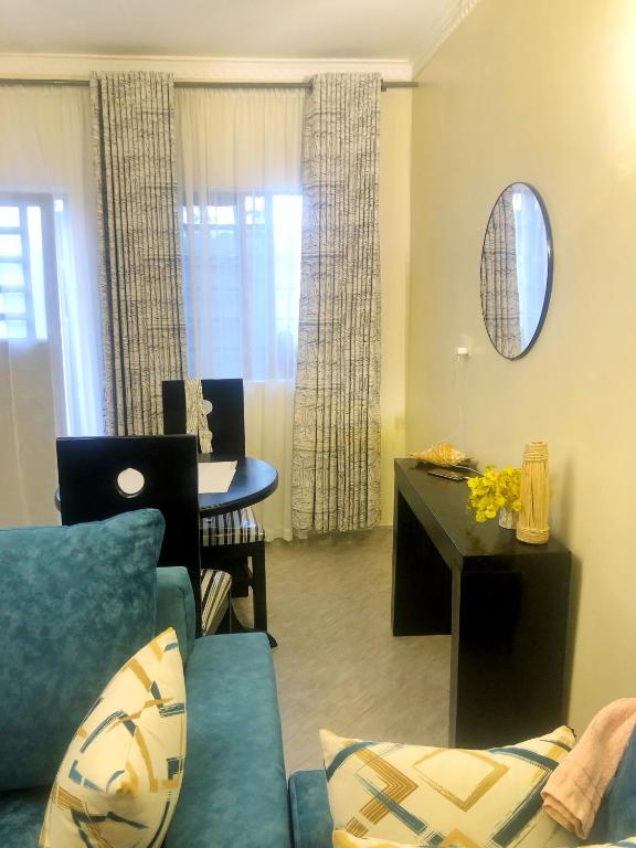 a living room with a couch and a table at Snowy stays in Eldoret