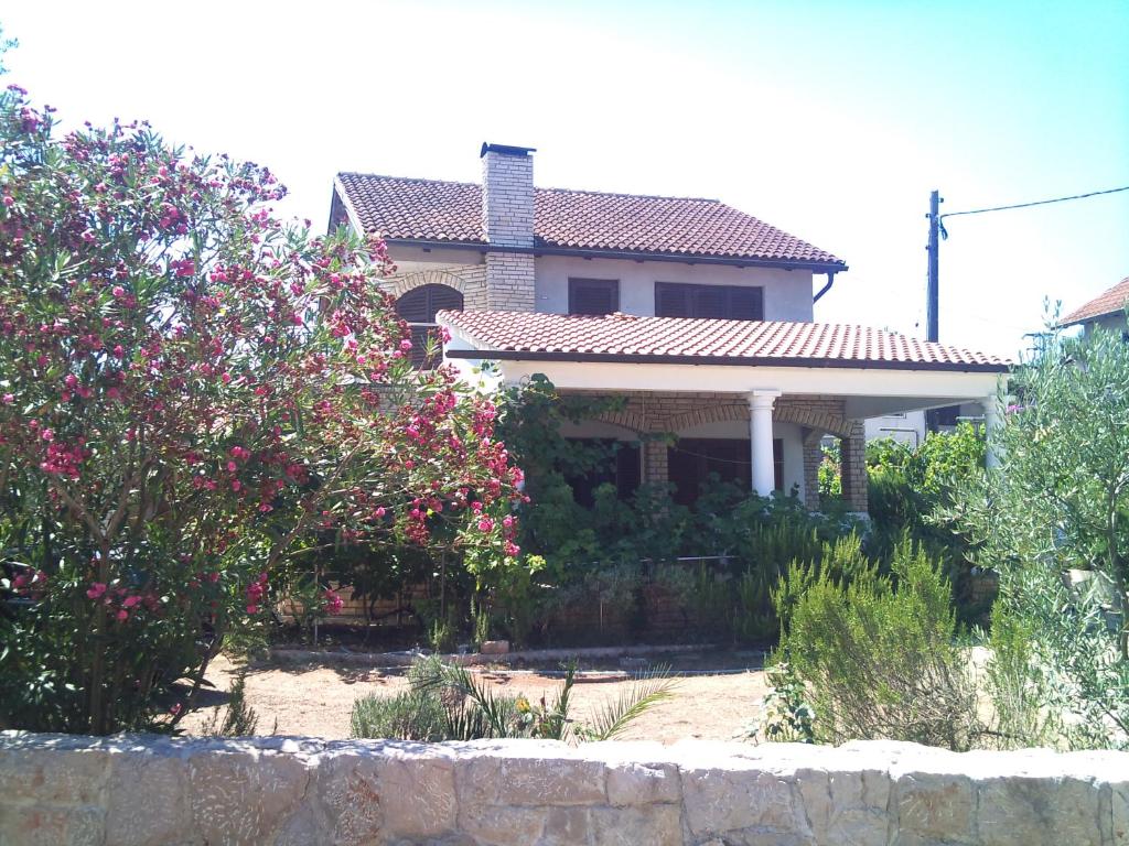 a house with pink flowers in front of it at Villa Sunny Side in Ždrelac