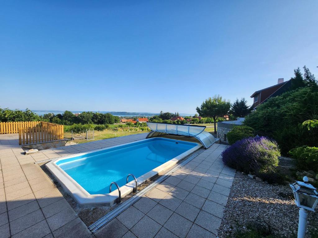 a swimming pool in a yard with a house at Lake Horizon in Balatonfüred