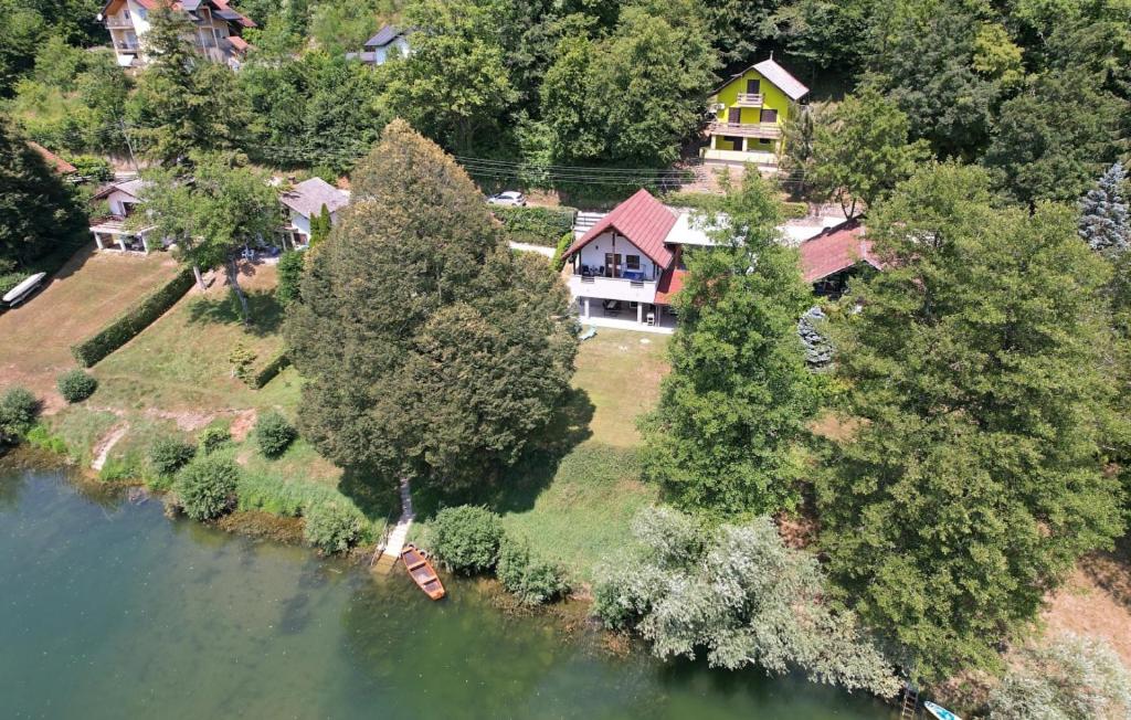 an aerial view of a house next to a lake at Holiday House Lucija by Villas Guide in Ozalj
