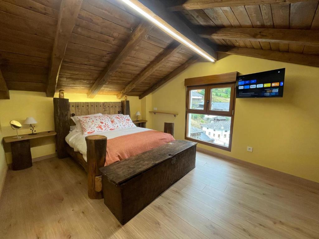 a bedroom with a bed and a large window at Apartamentos Rurales Casa Carloto 