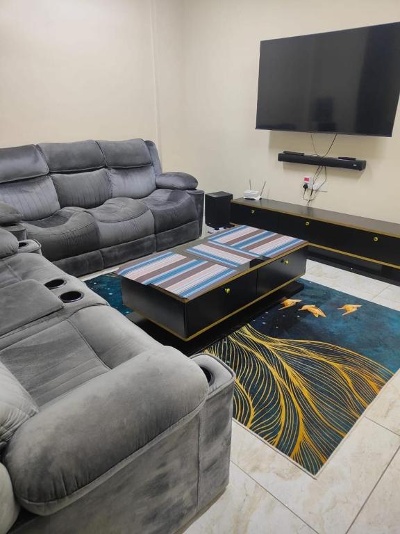 a living room with a couch and a flat screen tv at Lulu house in Mombasa