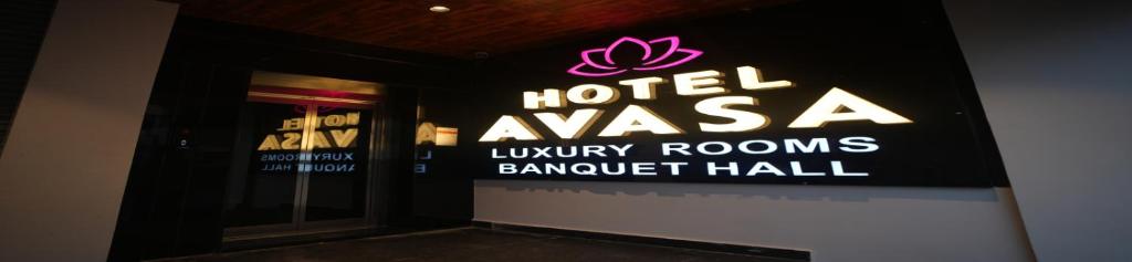 a sign for a hotel in a building at Hotel Avasa in Tenāli