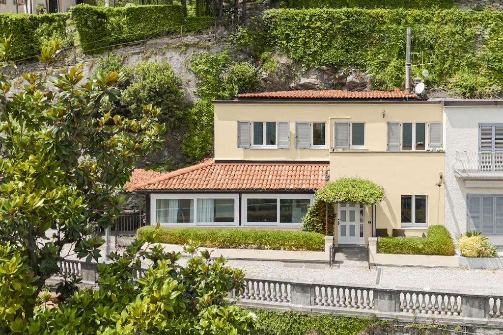 a large white house with a red roof at Luxury townhouse with panoramic Como lake views by Aura Luxury Collection in Carate Urio