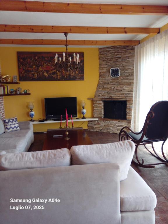 a living room with a couch and a fireplace at Villa Mondi in Durrës