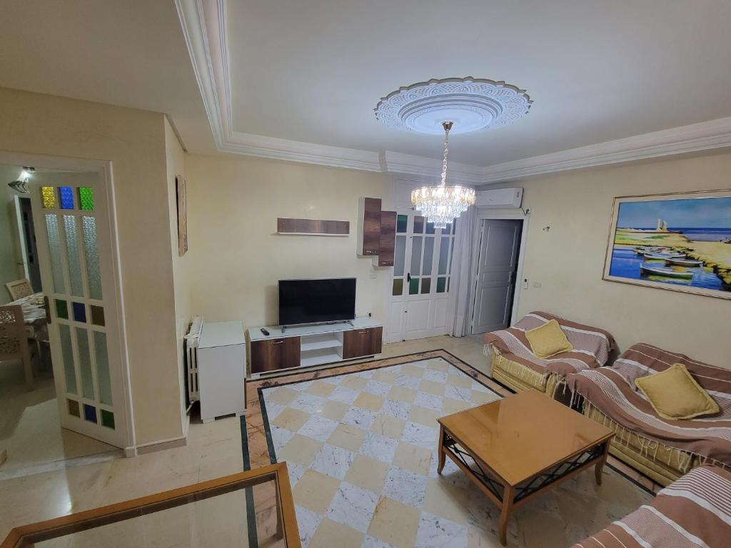 a living room with a couch and a table at mahdia old city luxury house in Mahdia