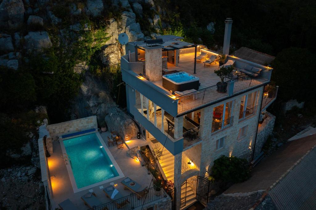 an aerial view of a house with a swimming pool at Holiday Home La Montagna - Private Heated Pool in Lokva Rogoznica