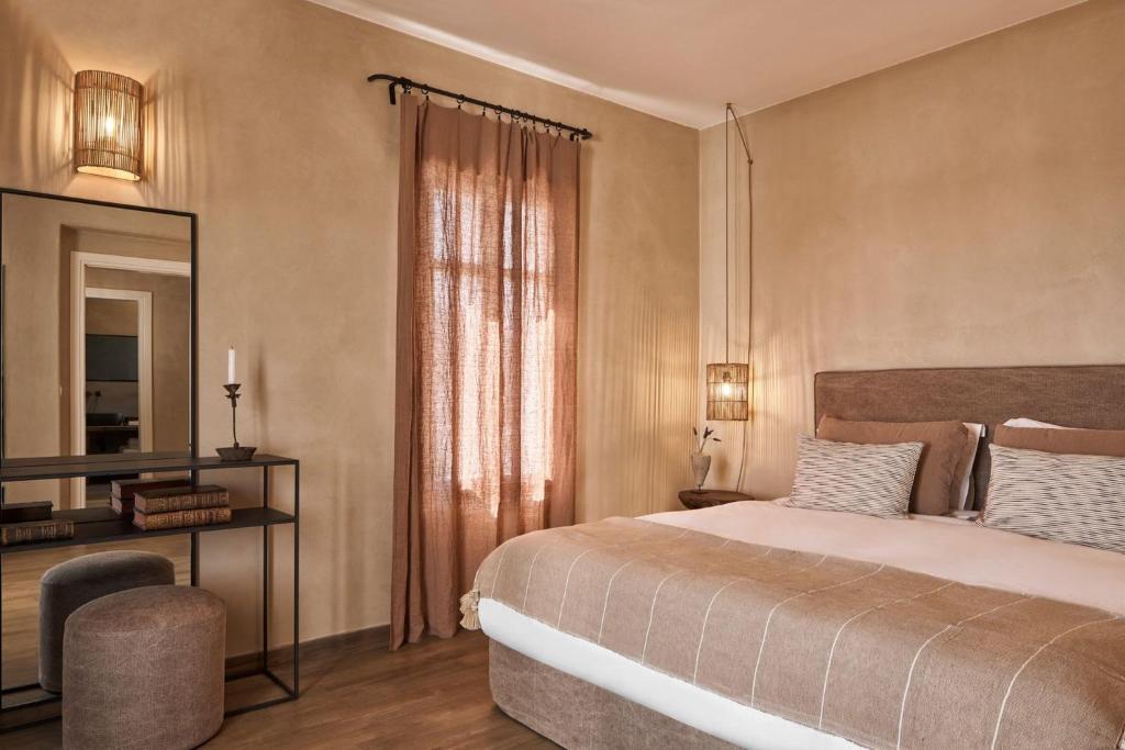 a bedroom with a large bed and a mirror at Luxury Naxos Villas Luxury Villa Air Conditioning Private Pool 2 Bedrooms Stelida in Naxos Chora