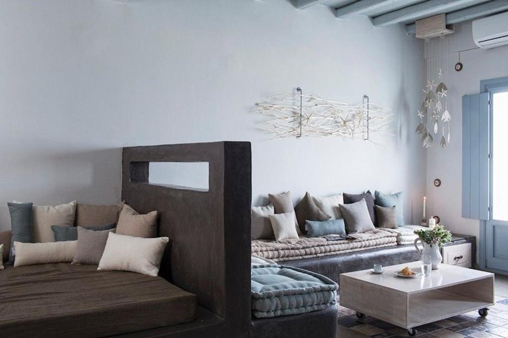 a living room with a couch and a table at Elegant Astypalaia Villa Villa Ble Air Conditioning Hot Tub in Astypalaia Town