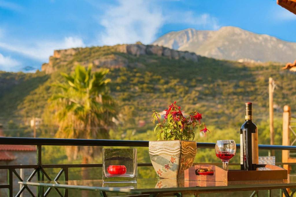 a table with a bottle of wine and a glass at Mani Garden Haven - Private Retreat in Stoupa in Levktron