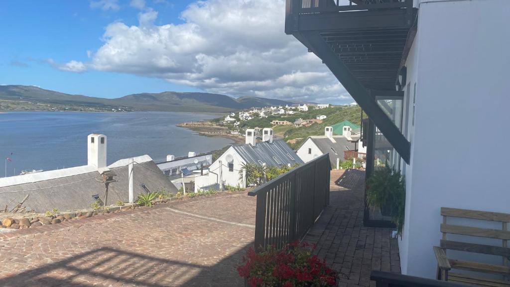 a balcony of a house with a view of the water at Witsand Holiday Flat in Witsand