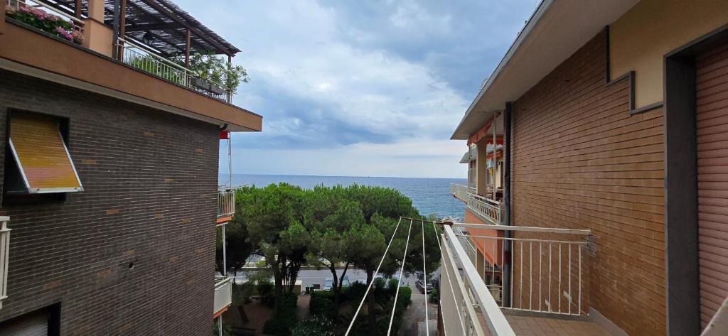 a balcony of a building with a view of the ocean at Ettorina in Cogoleto