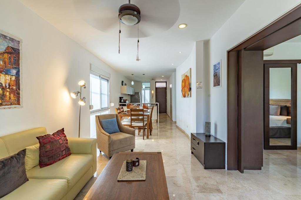 a living room with a couch and a table at Papaya Plus in Playa del Carmen