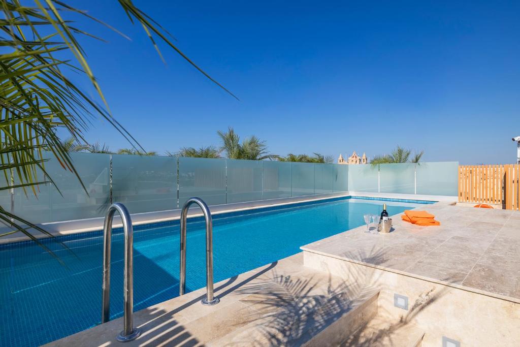 a swimming pool that is next to a building at Salmar Court Holiday Apartments with Pool in Hal Ghaxiak