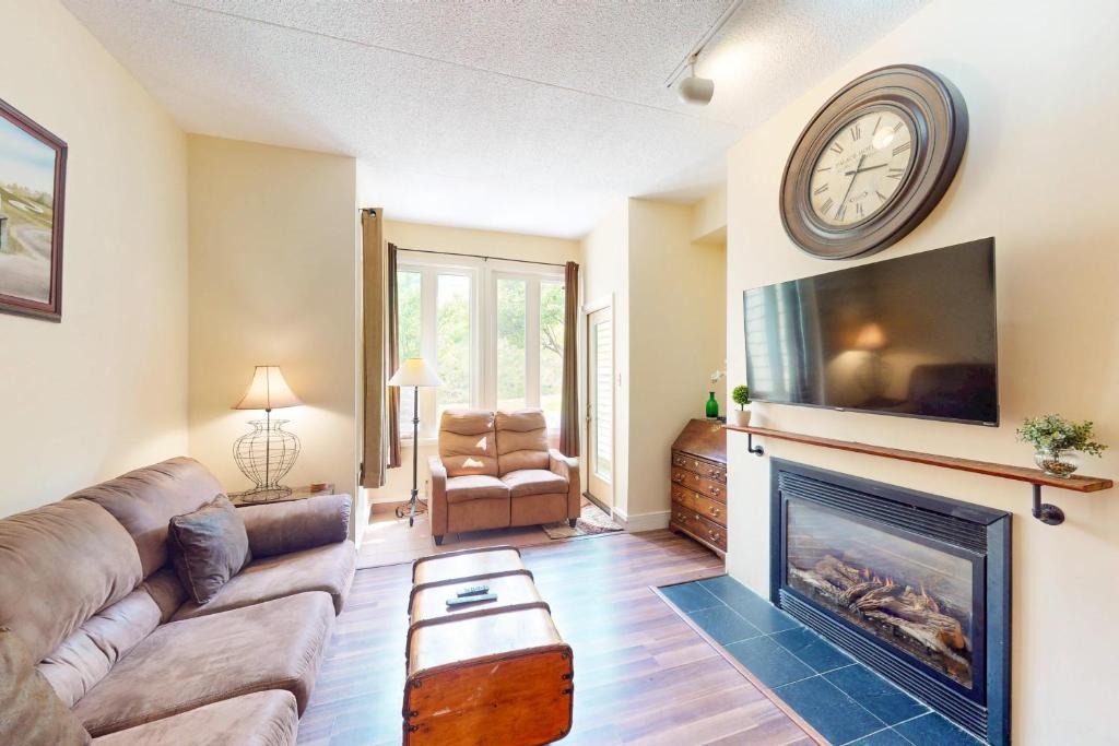 Una sala de estar con un sofá y una chimenea. en Chateau Ridge 109, en Blue Mountains