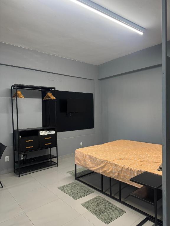a bedroom with a bed and a dresser and a mirror at Liv Stay in Brasília