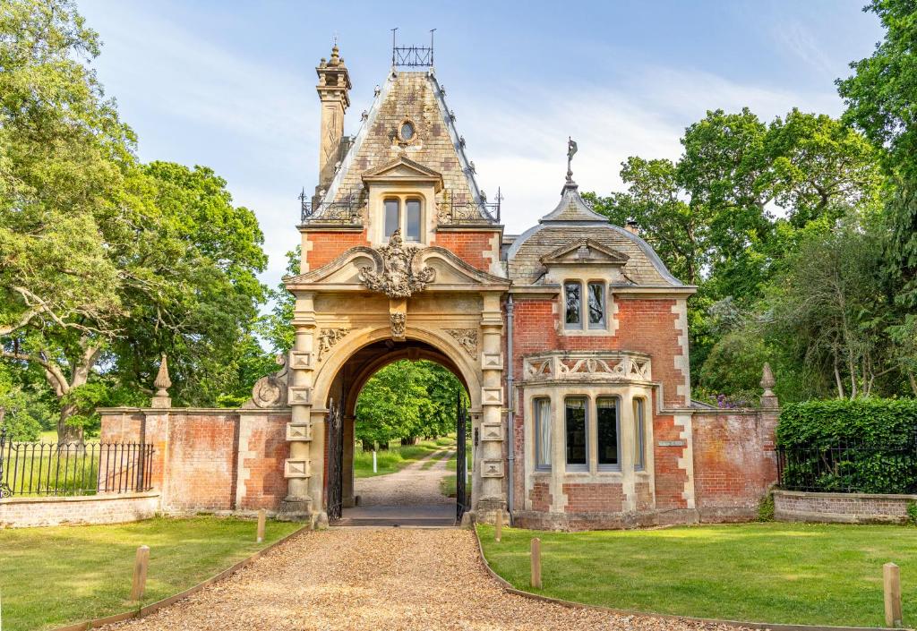 an entrance to an old house with an archway at Historic 2 bed gatehouse in private parkland in Brockenhurst