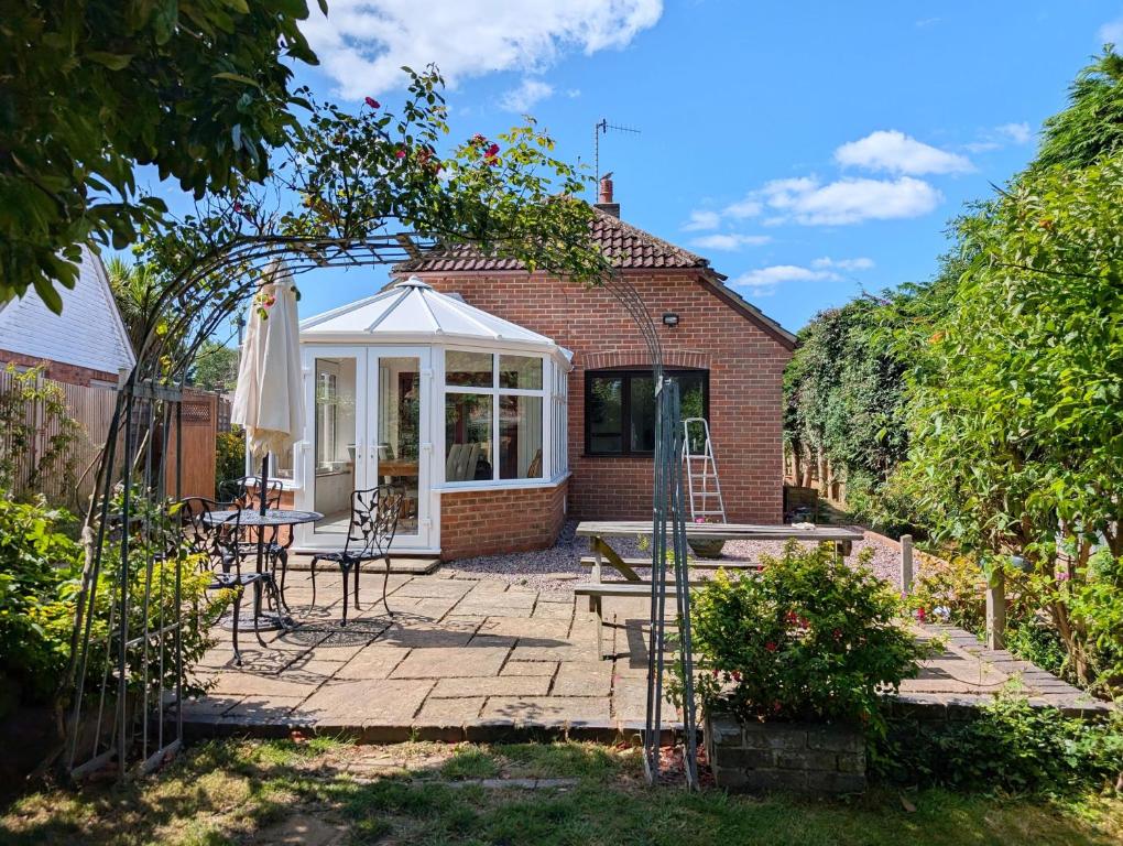 a patio with a table and a white gazebo at Barn Cottage in Wick