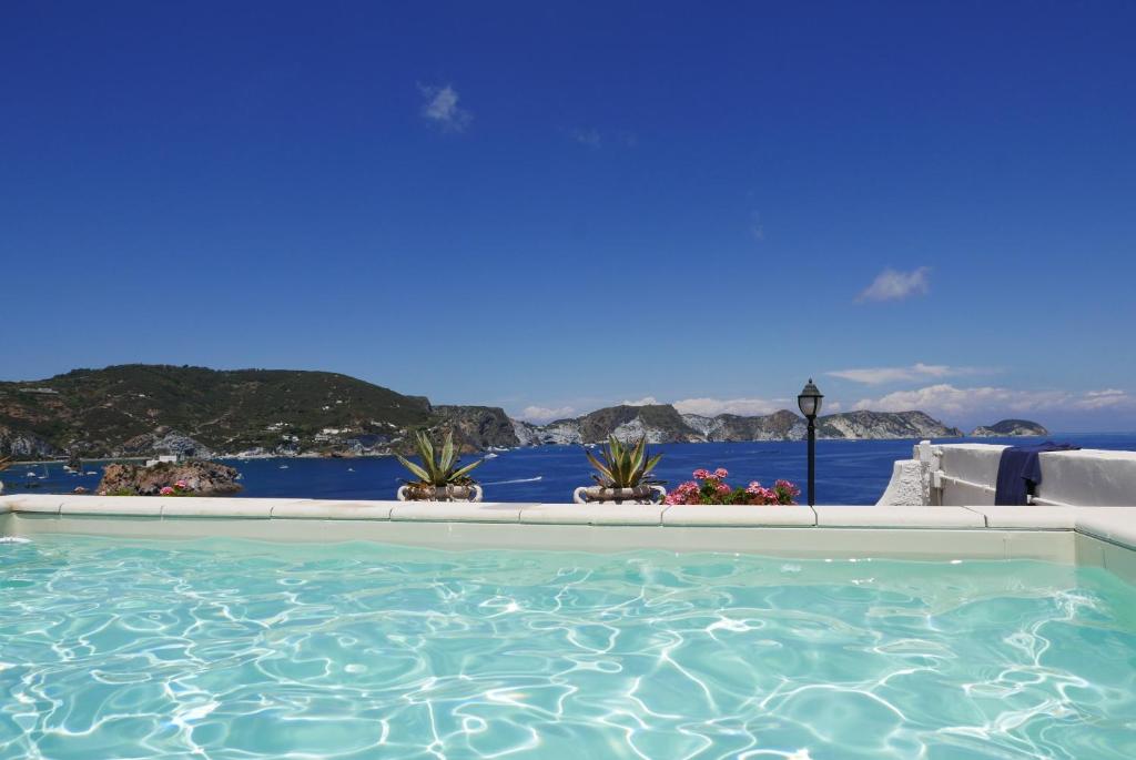 a beach with a pool and a swimming pool at Hotel Torre Dei Borboni in Ponza