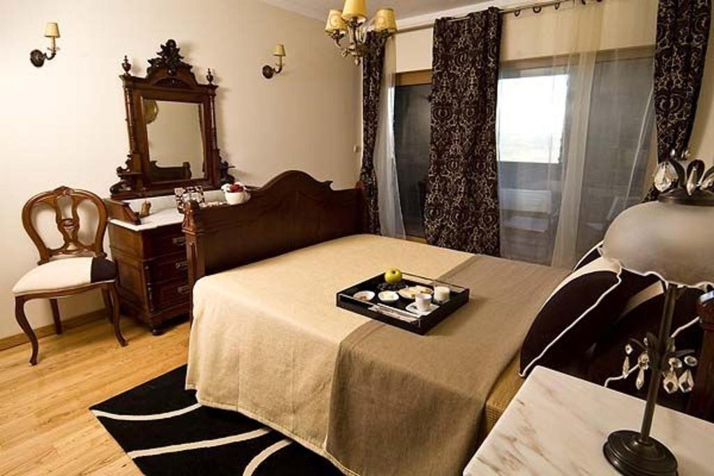 a living room with a bed and a mirror at Phenomenal Pinhao Villa 3 Bedrooms Villa Douroco Beautiful Valley Views Pool Table in Pinhão