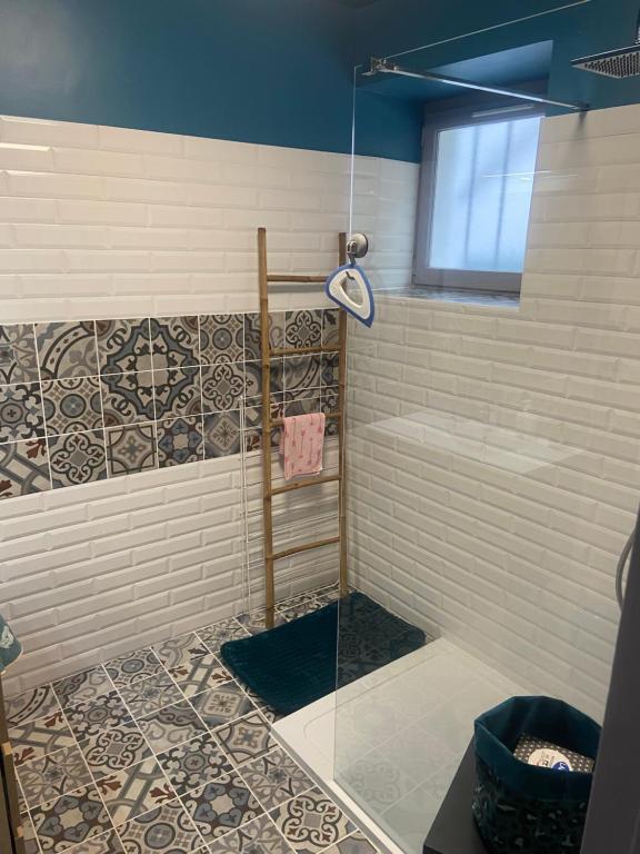 a shower with a glass door in a bathroom at La Cigale Ardéchoise in Labégude