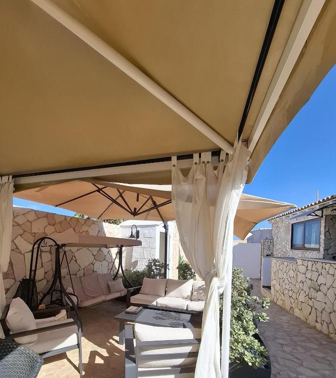 a large tan umbrella on a patio at Villa Lucia in Lampedusa