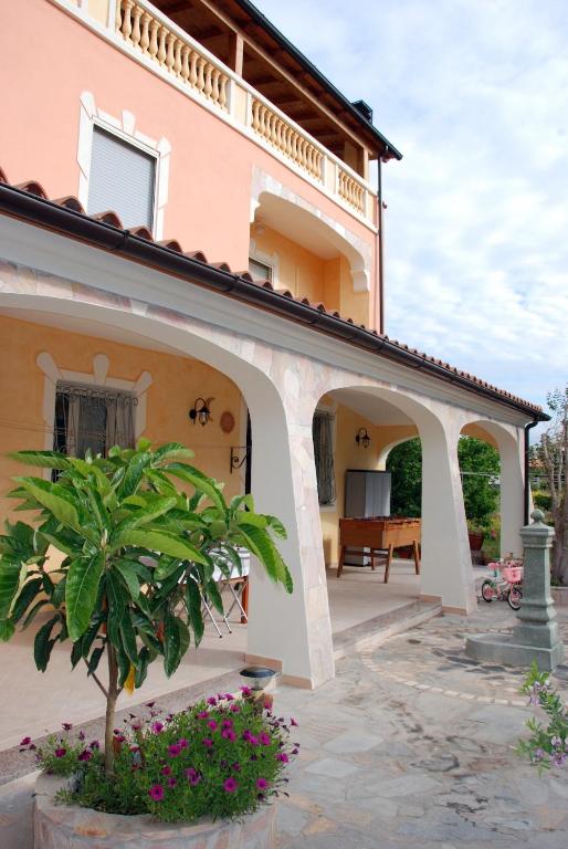 an external view of a house with a patio at Villa Lussu in Orosei