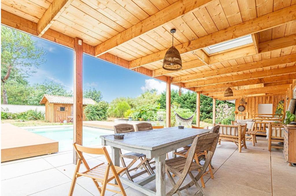 une salle à manger extérieure avec une table et des chaises dans l'établissement La Case d'Elista, à La Teste-de-Buch