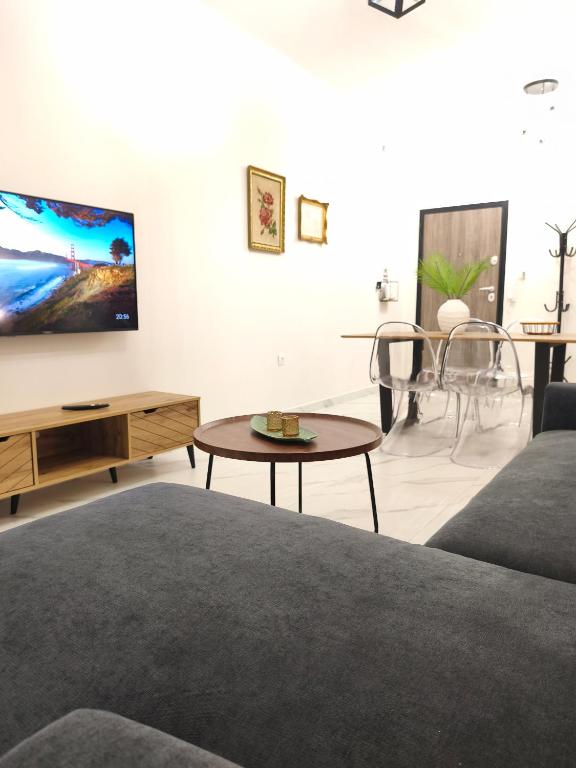 a living room with a couch and a table at LUX Central in Alexandroupoli