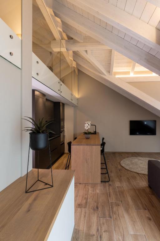 a living room with a staircase in a loft at Ariel Penthouse - In the heart of Domodossola in Domodossola