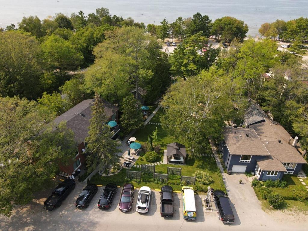 an overhead view of a yard with cars parked in a driveway at The Cozy Shore Cottage - Standard Single in Wasaga Beach