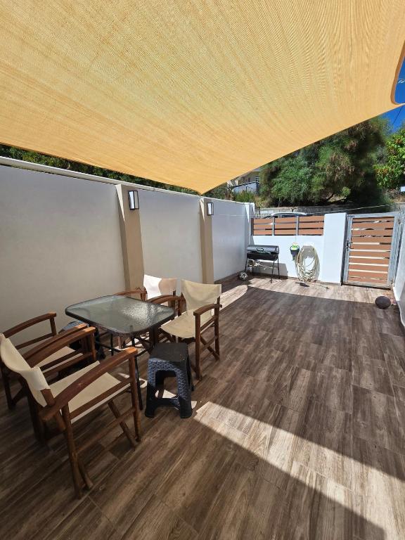 a patio with a table and chairs on a roof at La Casa di Levante in Zakynthos