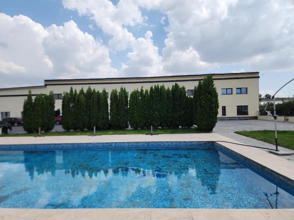 a swimming pool in front of a building at Politaly Hotel in Mayakovski