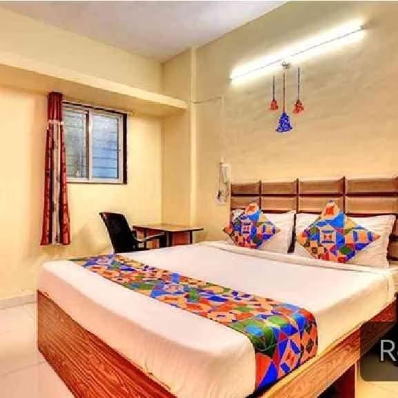 a bedroom with a large bed and a table at srh inn in Jāmb