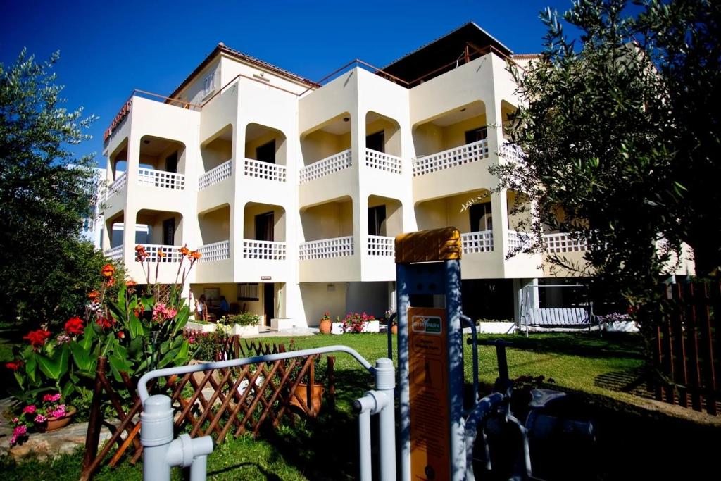 a white building with a lot of balconies at olivensun apartment 7 in Gythio