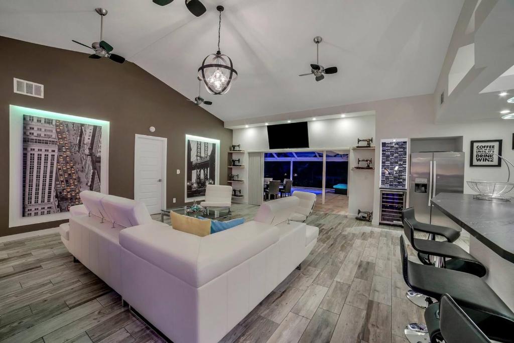 a living room with a white couch and a table at Villa Camelot - Gulf Access in Shell Point Village