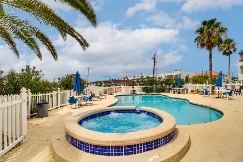a swimming pool with chairs and a fence at Swim, Fish and Suntan Cozy Corpus Christi Retreat in Corpus Christi