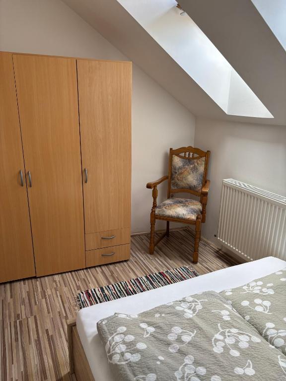 A bed or beds in a room at Bodzavirág Apartman