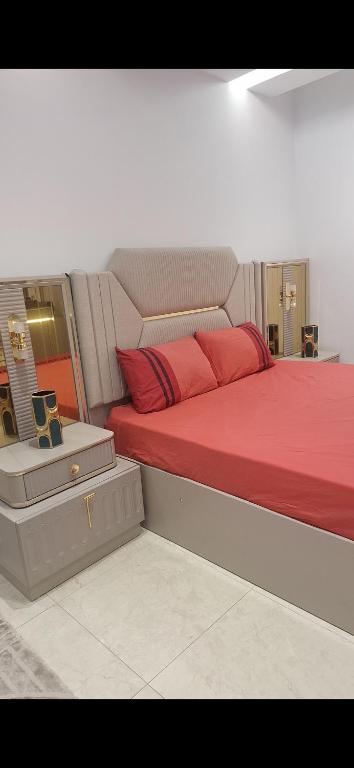 a bedroom with a bed with red pillows at Villa au centre ville Rabat in Rabat