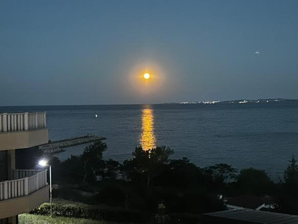 a view of the ocean at night with the sun setting at Sea View Luxury Apartment in Bŭnzareto