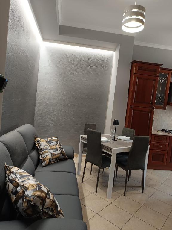 a living room with a couch and a table at CasaNorah in Fondi