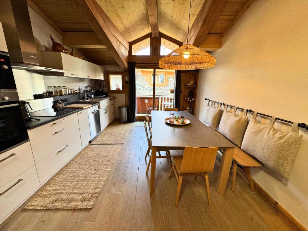a kitchen with a table and chairs in a room at Chalet Aster - Maison de village rénovée sur 3 niveaux 4 pièces pour 6 personnes à St Marcel MAE-6444 in Saint-Marcel