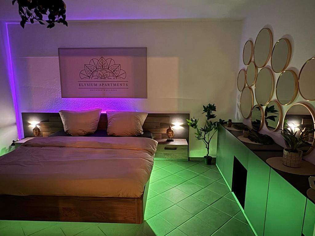 a bedroom with a bed with purple and green lighting at Wellnesshaus - Whirlpool, Sauna, Küche, 24-7 in Herten