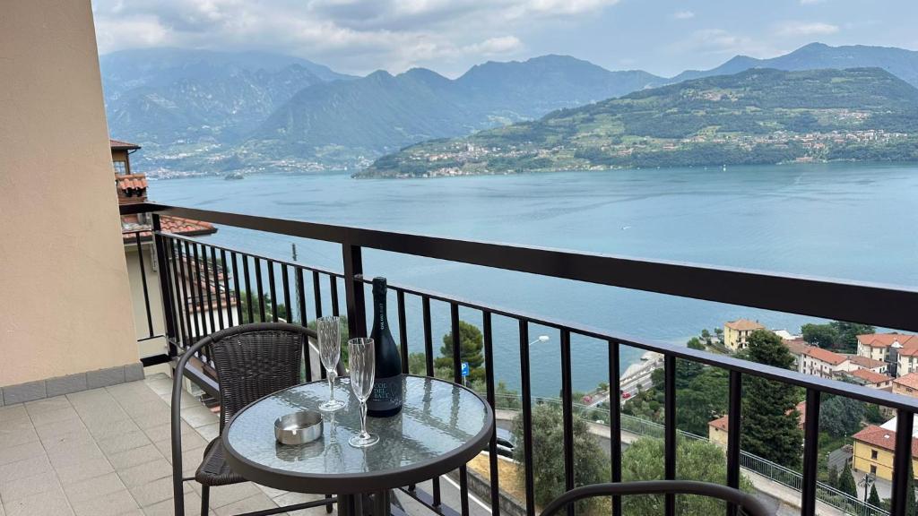 a table and chairs on a balcony with a view of the water at La Vista in Tavernola Bergamasca