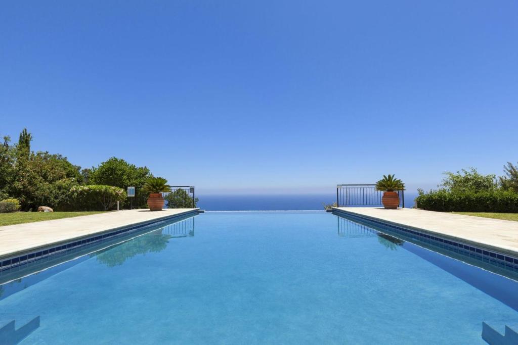a swimming pool with a view of the water at Aphrodite Hills Elite Villas Elite Superior Villa 0266 Private Pool 3 Bedrooms Paphos in Paphos