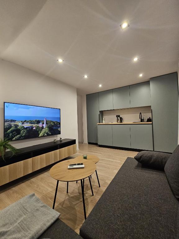 a living room with a couch and a table at Zvaigžņu apartment in Riga