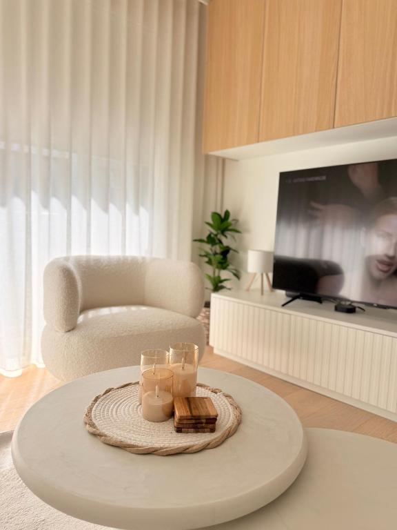 a living room with a table with candles on it at Studio Nacre Knokke in Knokke-Heist