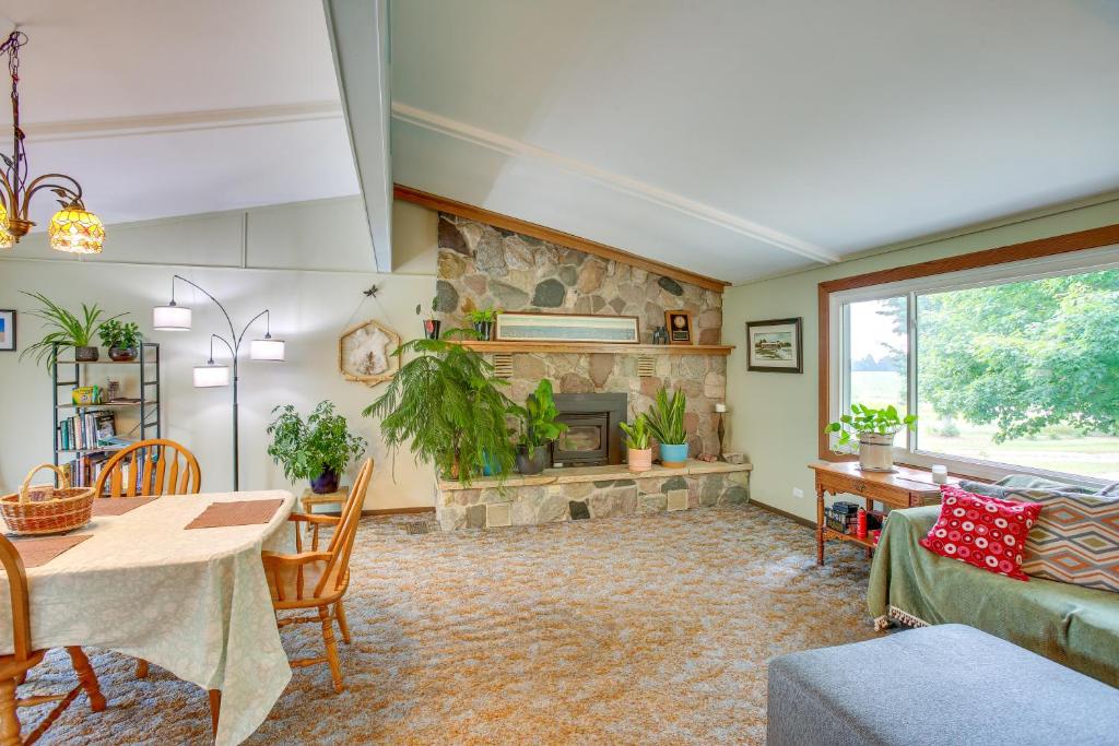 a living room with a couch and a fireplace at 8 Mi to Crystal Mountain Peaceful Up North Home in Thompsonville